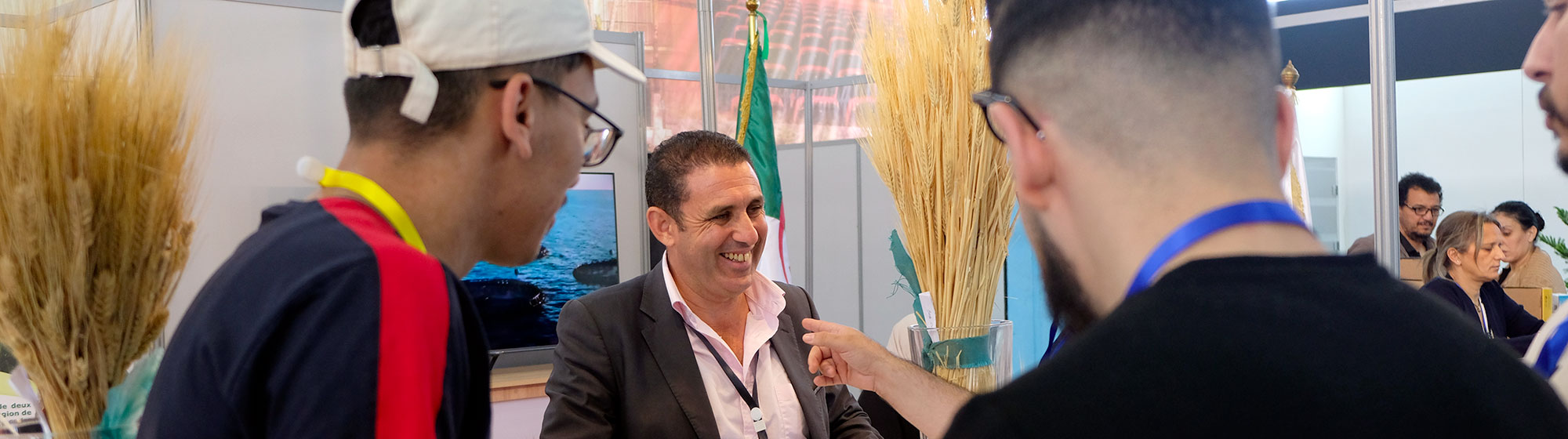 Man managing a stand and welcoming visitors