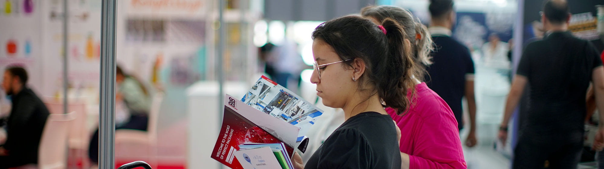 Two women reading several brochures