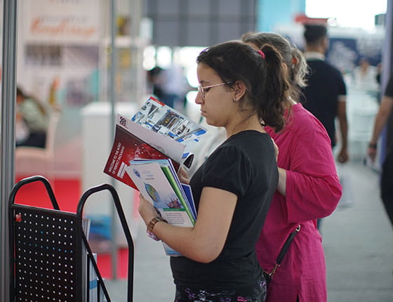 Two women reading several brochures