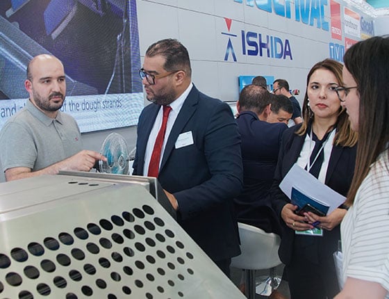 Visitors attending an exhibitor demonstration