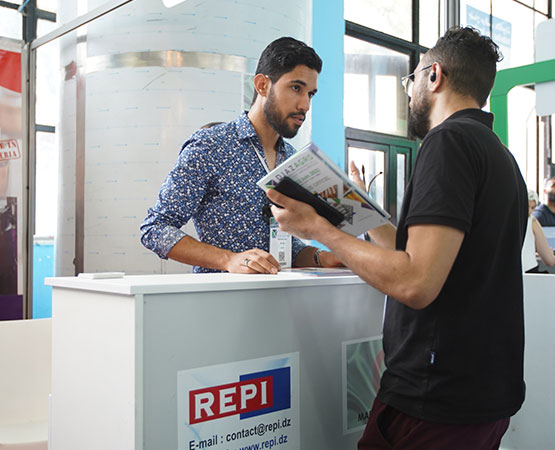 Two men discussing a brochure